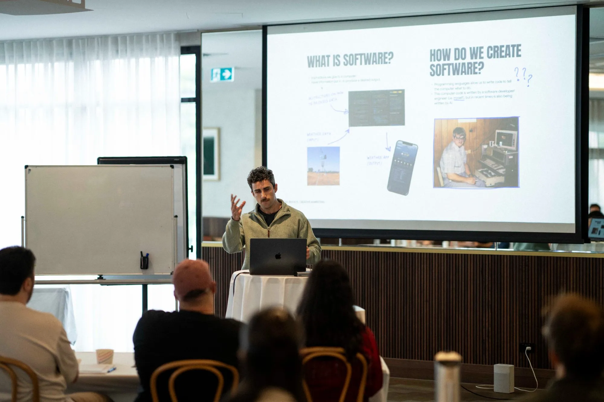 A Q Agency developer presenting how software gets built to the team