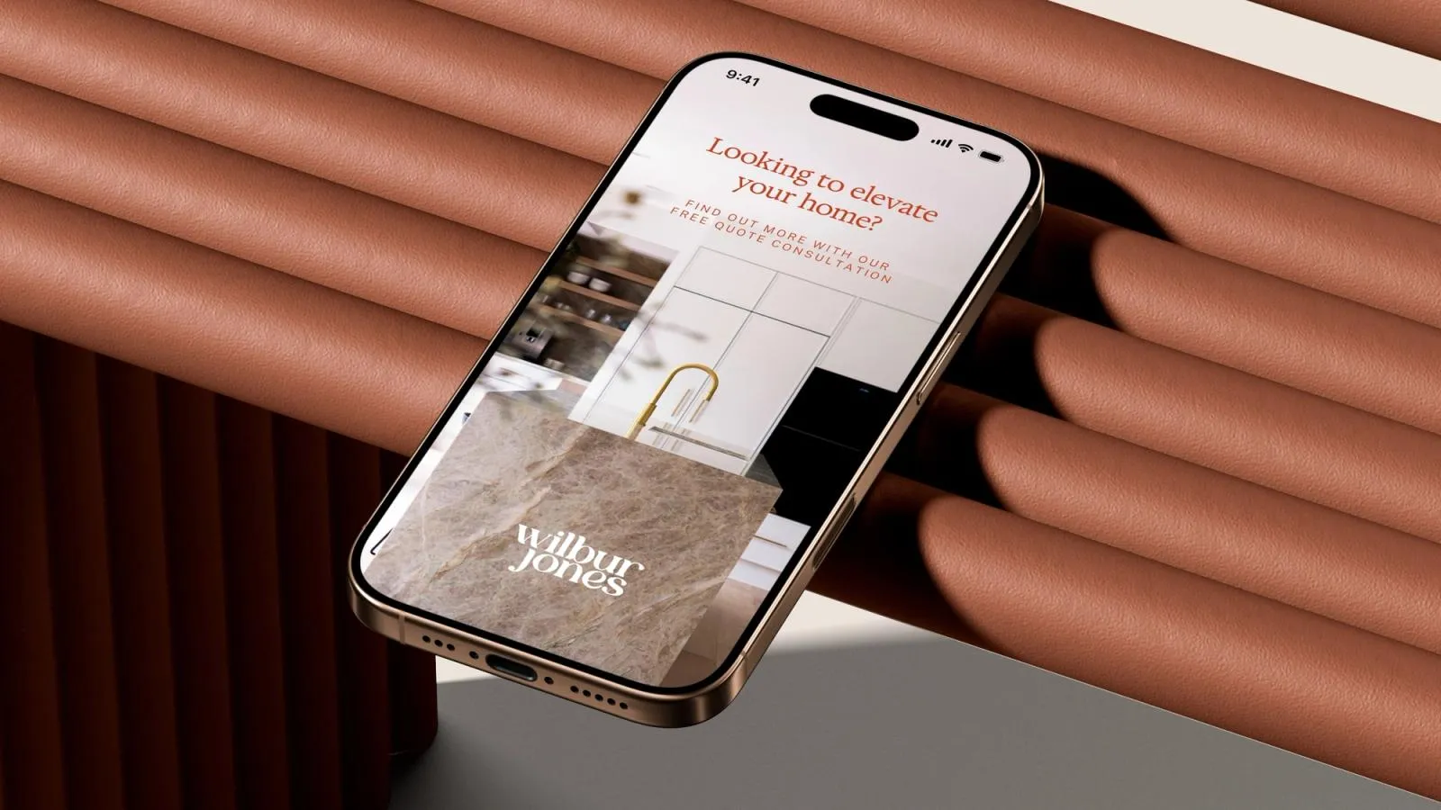 Phone showing a Wilbur Jones ad, "Looking to elevate your home?", offering a free quote consultation