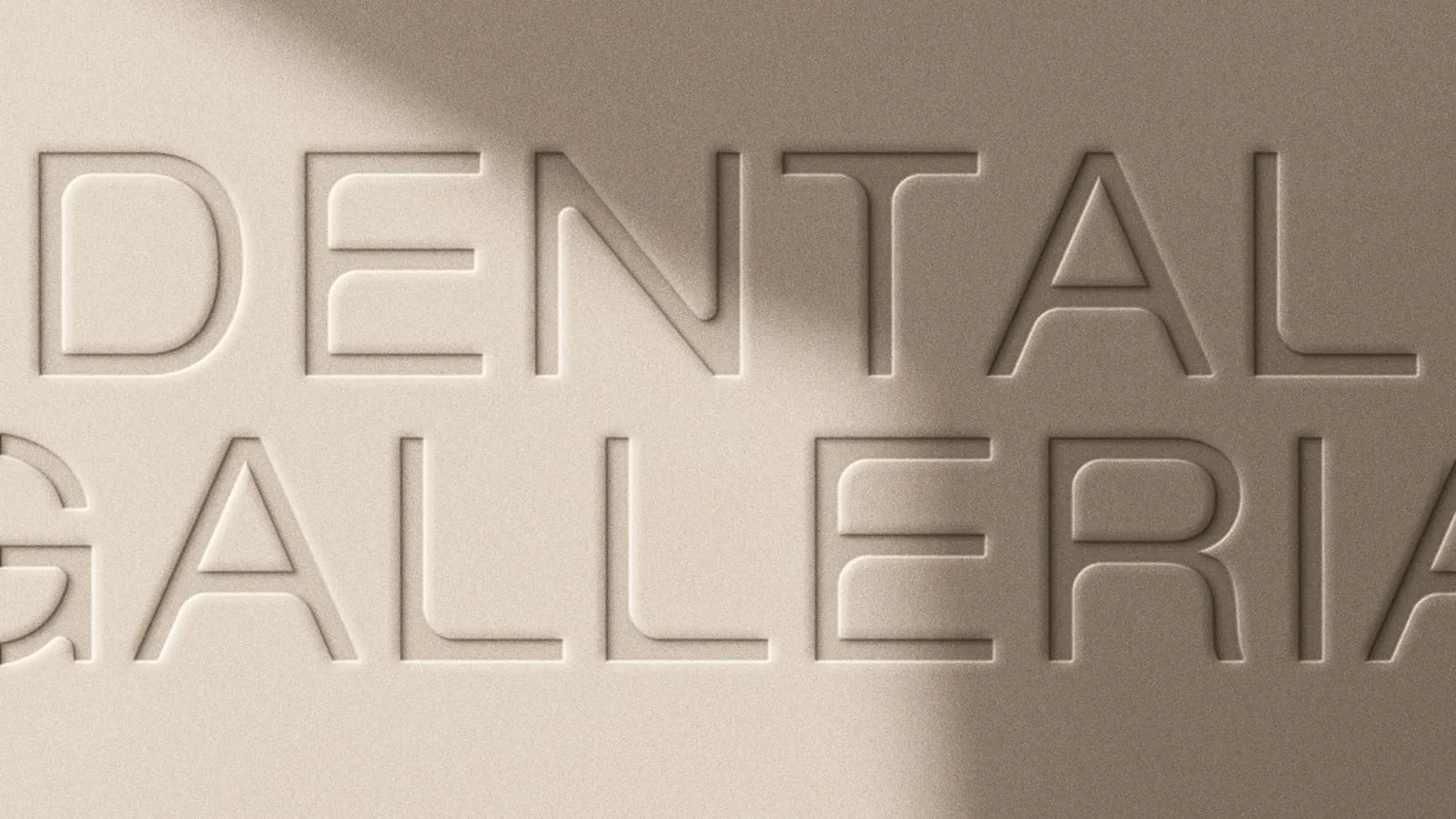 The Dental Galleria wordmark debossed into warm beige card stock