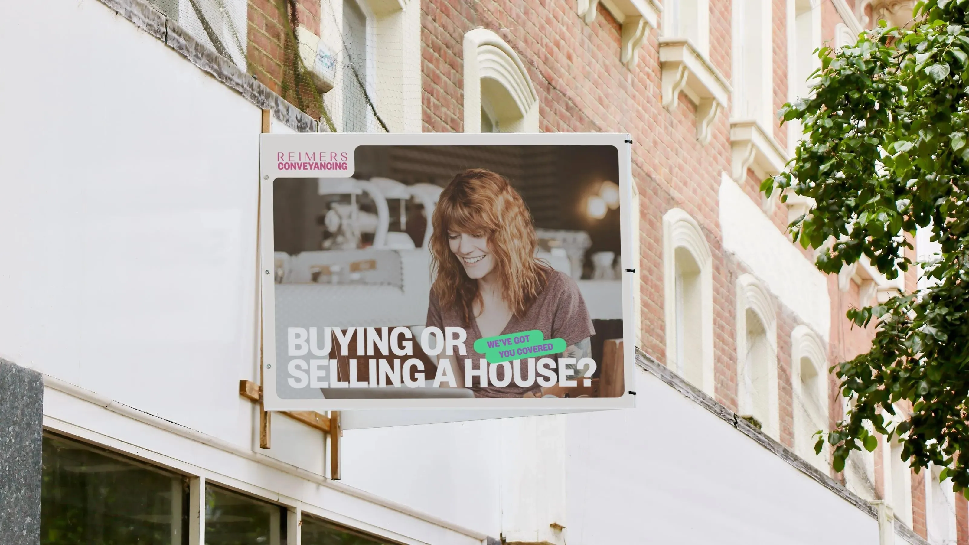 Hanging street sign for Reimers Conveyancing: "Buying or selling a house? We've got you covered"