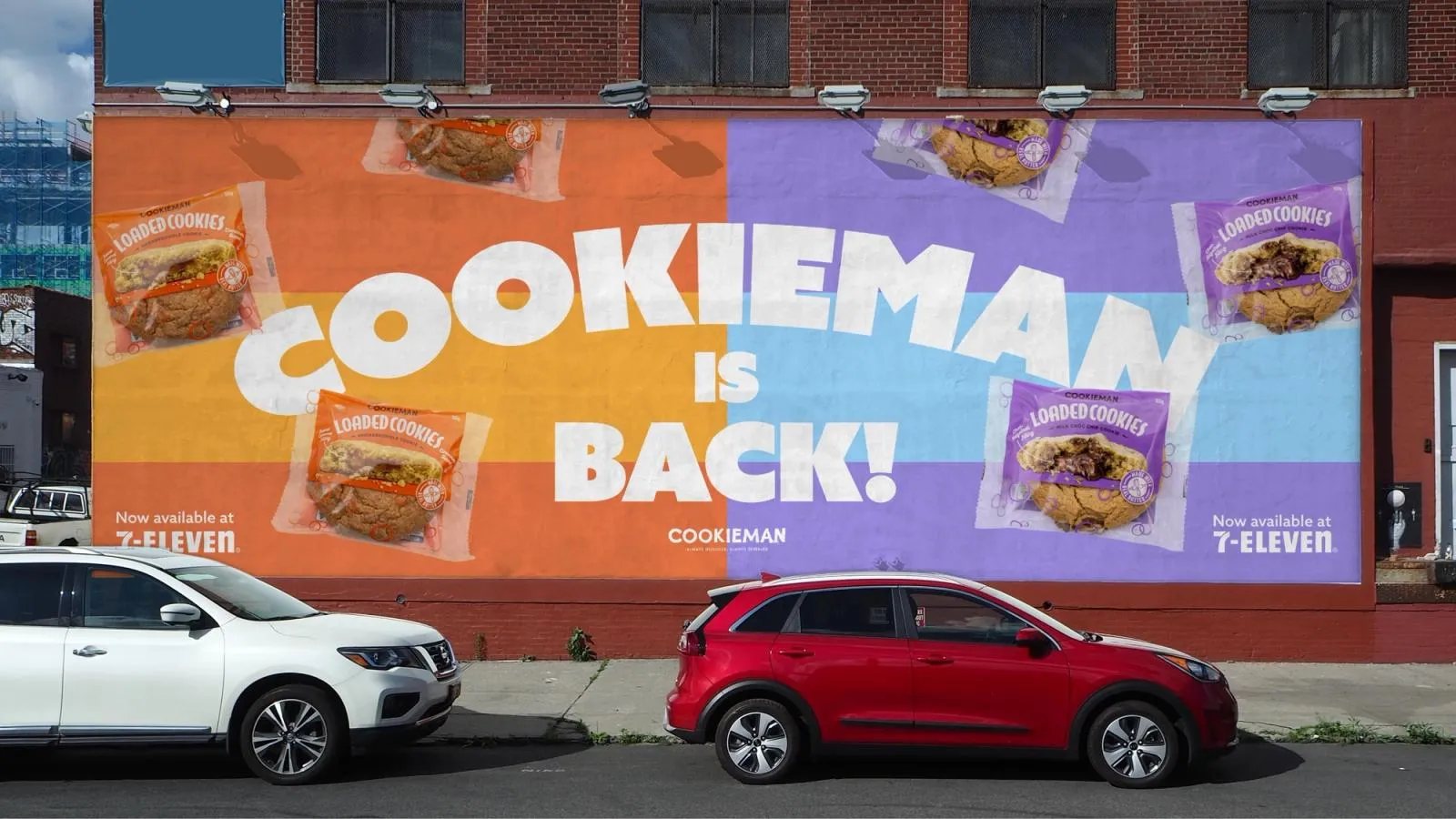 Street wall billboard declaring "Cookieman is back!", with Loaded Cookies now available at 7-Eleven