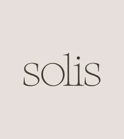 The Solis serif wordmark in charcoal on a warm stone background