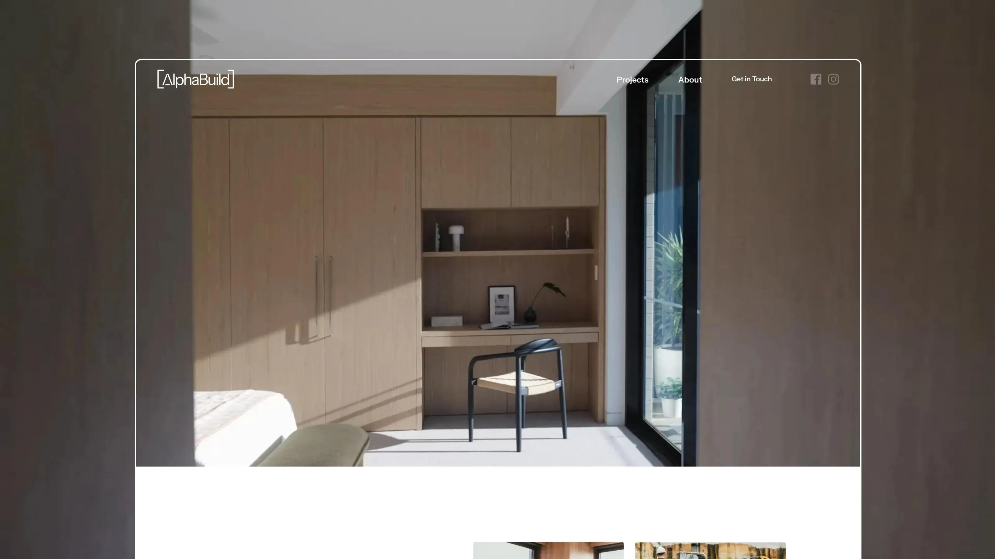Website hero for Alpha Build framing a bedroom with timber joinery and a built-in study desk