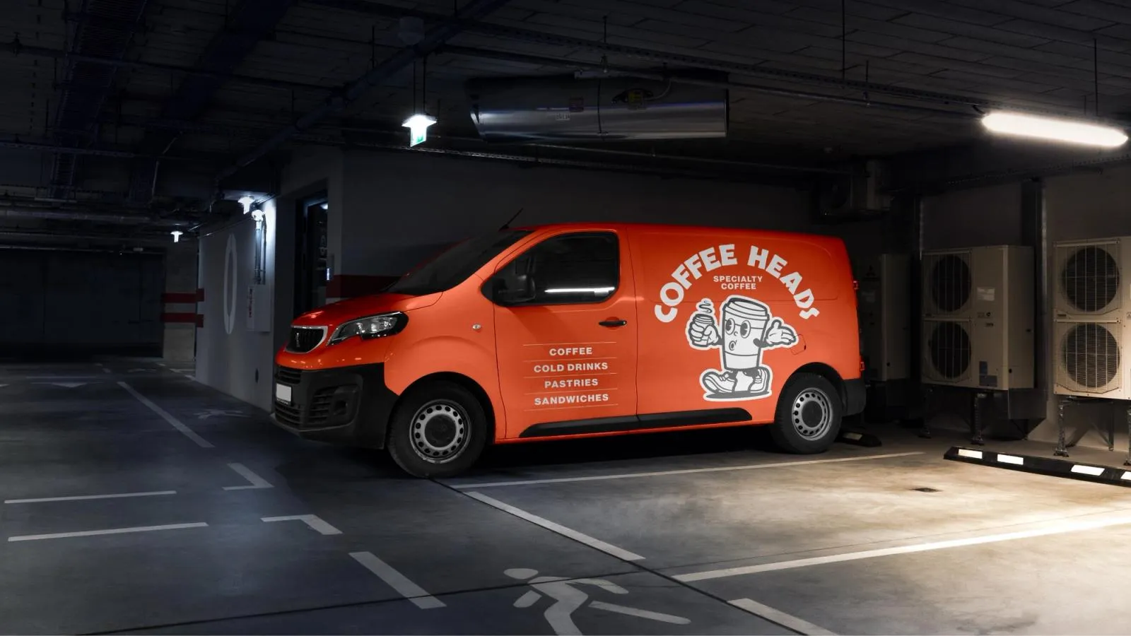 Orange Coffee Heads delivery van carrying the mascot and menu, parked in an underground car park