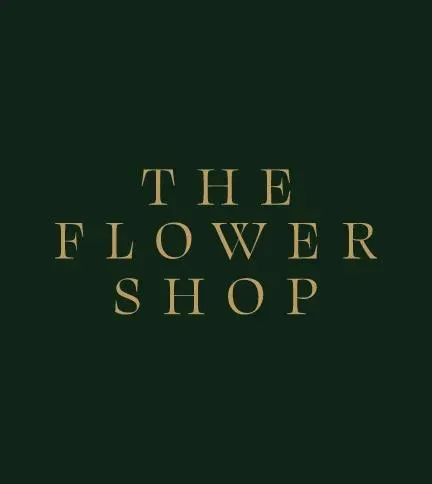 The Flower Shop wordmark set in gold serif capitals on deep green